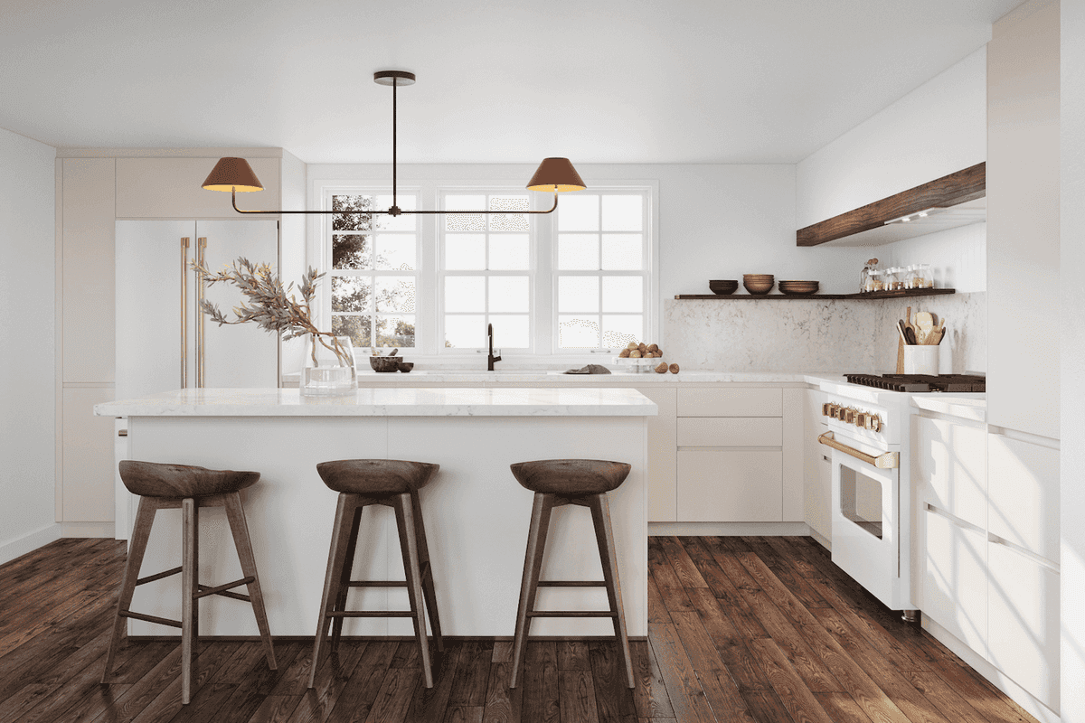 Modern kitchen interior featuring a white island with marble countertop, accompanied by three rustic wooden stools. The space is illuminated by a sleek black pendant light fixture with two warm-toned, angled lampshades. Behind the island, large windows allow natural light to flood the room, highlighting cream-colored cabinetry and a marble backsplash. The kitchen includes a white range with brass accents, open wooden shelving displaying minimalistic dishware, and dark hardwood floors that add contrast and warmth to the light-toned decor.