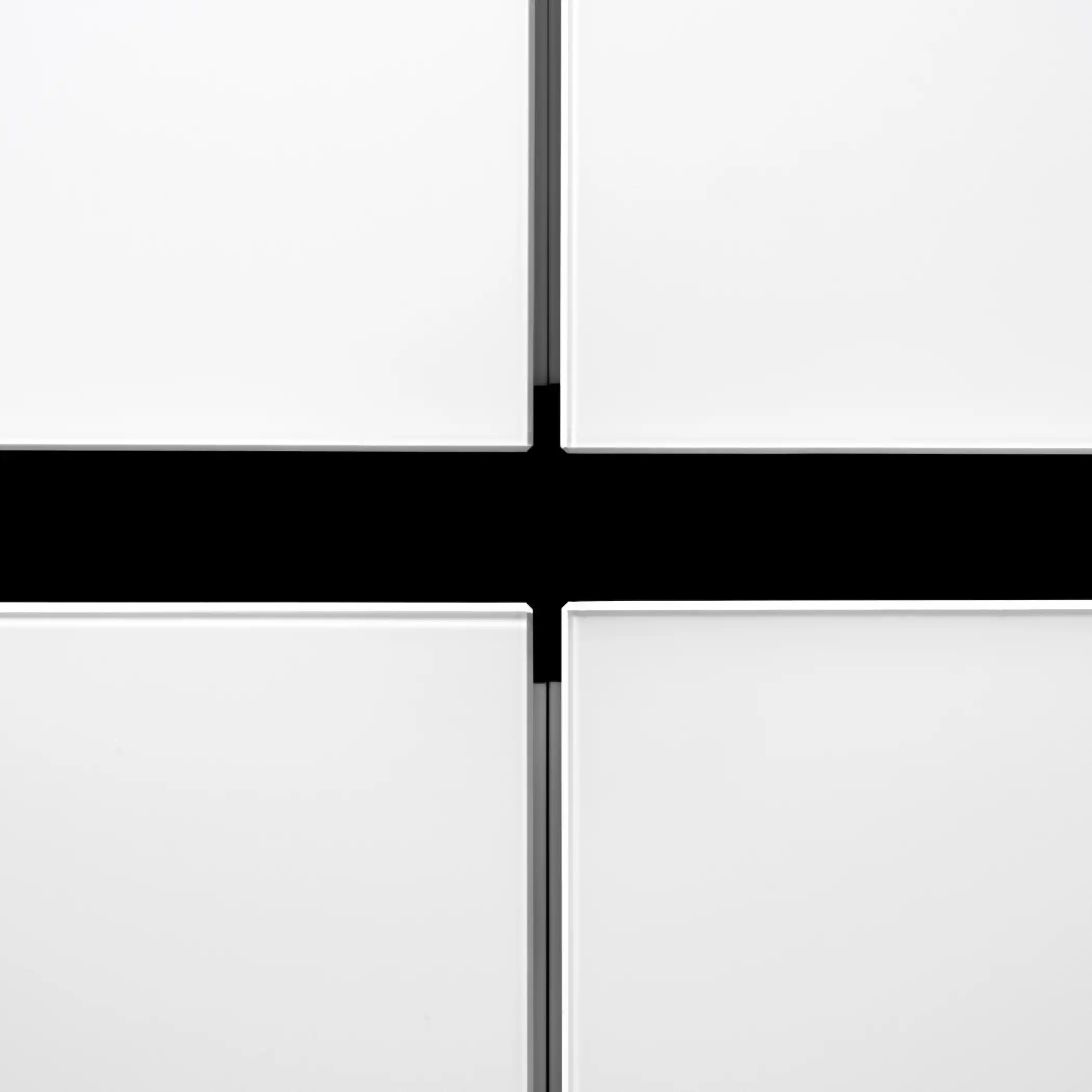 Close-up view of white kitchen cabinets with a bold black line detail at the junction where the cabinet doors meet. This simple yet striking feature highlights the clean lines and minimalist design of the cabinetry, emphasizing a modern and sleek aesthetic.