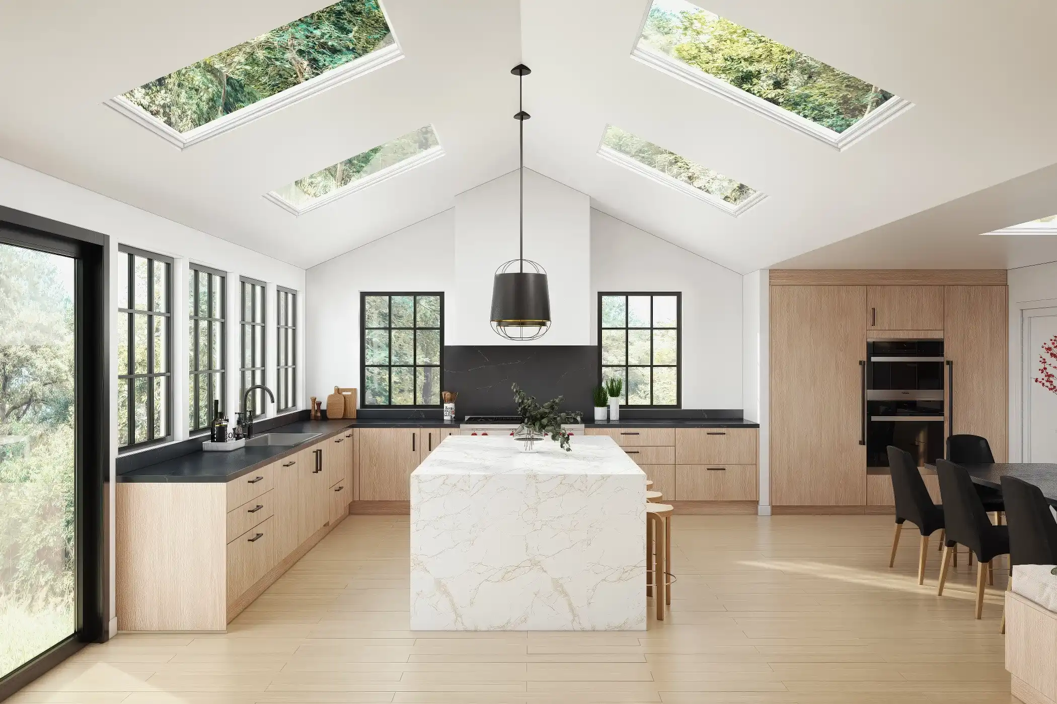 This spacious kitchen features flat-front cabinets with sleek handles, combining light wood finishes with a striking marble island. The open layout is enhanced by large skylights and floor-to-ceiling windows, flooding the space with natural light. The contrasting black countertops add depth to the design, while the island serves as a central focal point, offering both functionality and elegance. The blend of natural materials and modern design elements creates a warm and inviting kitchen environment.