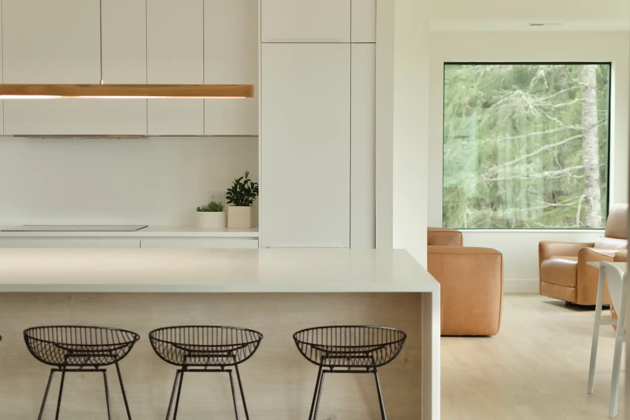 Contemporary kitchen bathed in natural light, showcasing a harmonious blend of white cabinetry and our Oak Montreal cabinets.